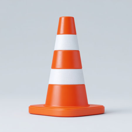 A vibrant orange traffic cone featuring white reflective stripes, ideal for construction, maintenance, or safety applications in urban settings.の素材