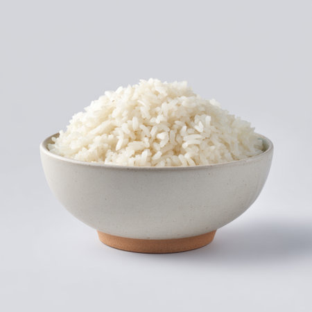 This image features a bowl of freshly cooked white rice, showcasing its fluffy texture and simplicity, ideal for culinary or food-related projects.の素材
