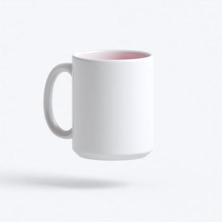 This minimalistic white coffee mug features a pink interior and is captured in a floating position against a soft background, perfect for creative projects.の素材