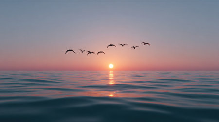 Experience the beauty of a tranquil sunset over the calm ocean, as silhouetted birds gracefully fly across the colorful sky at twilight.の素材