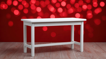 A striking white table positioned against a vibrant red background adorned with bokeh lights, perfect for showcasing decor, styling, and photography.の素材