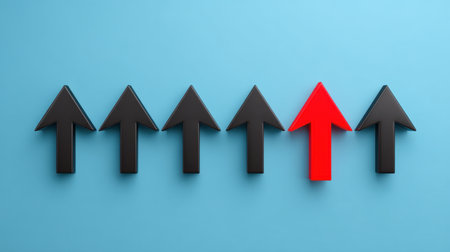 A striking image showcasing a single red arrow standing out among a series of black arrows on a blue background, representing individuality and progress.の素材