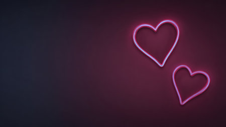 Two glowing neon hearts in pink light against a dark background, perfect for representing love, romance, and affection in various design contexts.の素材