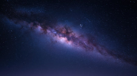 This stunning image captures a magnificent galaxy filled with dazzling stars and vibrant nebulae, showcasing the beauty of the cosmos at night.の素材