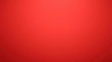 A bright red background showcasing a vivid and smooth texture, perfect for creative projects, bold designs, and modern artistic expressions.の素材
