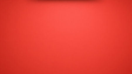 This vibrant minimalist image showcases a soft light against a rich red background, perfect for creative projects, advertisements, or graphic designs.の素材