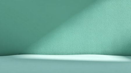 A serene and minimalistic interior showcases a mint green wall and floor, illuminated by soft light and gentle shadows, creating an inviting atmosphere.の素材