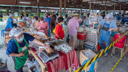 New normal way of life after Covid 19 lockdown. People get out to local market with self-protection and keep social distancing.のeditorial素材