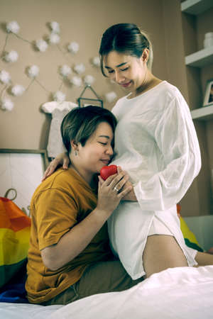 Young lesbian couple sre delighted by the pregnancy's test. Joy and bonding concept.の写真素材