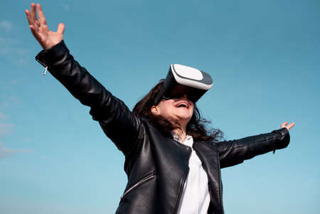 Woman with glasses of virtual reality on blue.