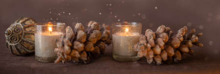 candles pine cones and christmas decoratoin