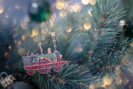 Christmas background with old vintage locomotive and garland lights.