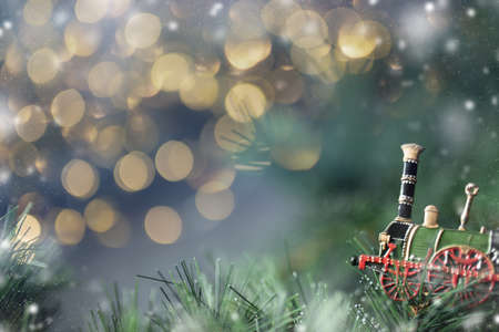 Christmas background with old vintage locomotive, garland lights and text area.