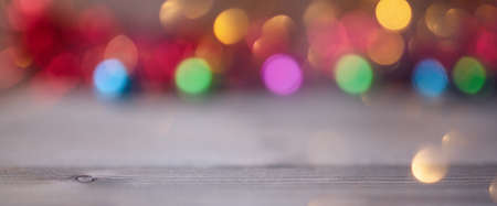 Soft light bokeh over wooden background. Copy space.
