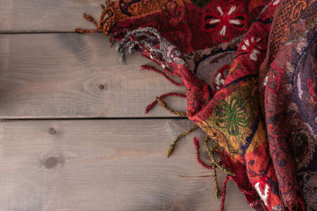 textured scarf on wooden background with space for your text or product