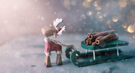 Christmas holiday background with toy moose and sledge.