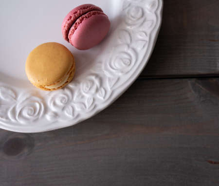 macarons in the white plate on the table. Top view, flat lay, copy spaceの写真素材
