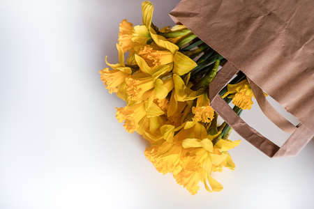 recycling, shopping and ecology concept with daffodilsの写真素材