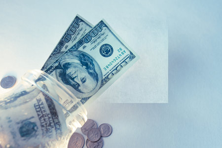 Dollar bills in the glass on the table.の写真素材