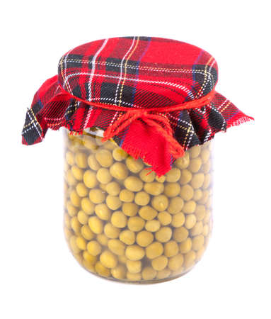 Canned peas in a glass jar with a fabric roof isolated on whiteの写真素材