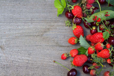 Mix of fresh, juice berries on wooden backgroundsの写真素材