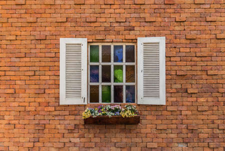 White wood window on the brick wall.