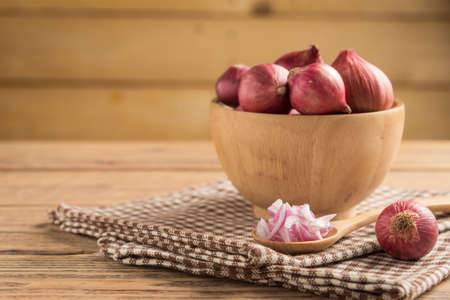 Sliced onion in spoon and red onion in bowlの写真素材