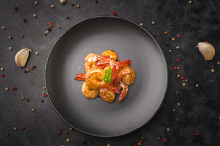 Fried shrimp with deep garlic and pepper on black background.の写真素材