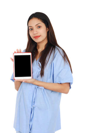 Isolated portrait of long hair beautiful woman smiling and showing tablet on white background. Business and medical concept.の写真素材