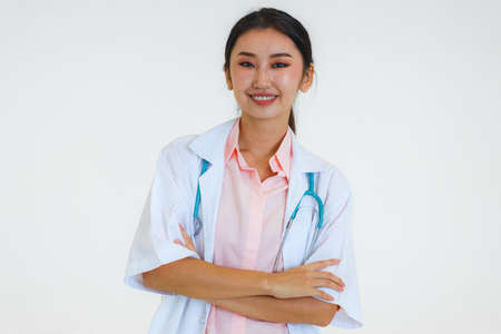 Portrait Young Asian female doctor smiling on white background.の写真素材