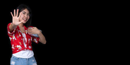 Young Asian women with ancient bowls Preserve the good culture of Thai people during the Songkran festival on black background. Thai New Year, Family Day in Aprilの写真素材