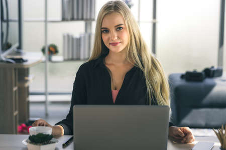 Young business woman working from home-office with morning sunshine. woman communicating in social...