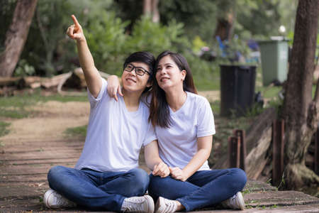 Lesbian couples doing activities and resting in the park on vacation. LGBT concept.の写真素材