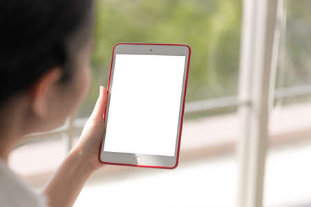 Close up tablet for mock up. Young women use tablet to entertainment Communicate and transact...