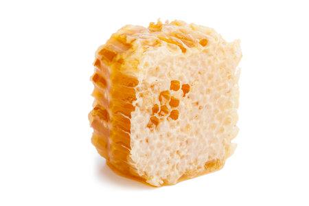 Close up honey slice isolated on white background. Natural beehive. Honeycomb pieceの写真素材