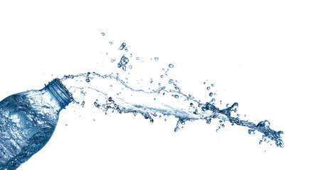 isolated of water splashing form the bottle on white background.の写真素材