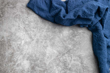 Blue fabric on cement background.