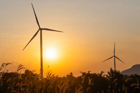 Silhouette of wind turbines with sunset background. ecology concept.の写真素材