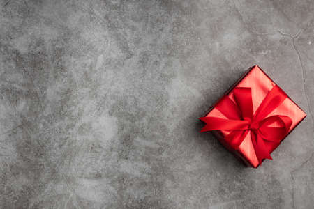 Top view of red gift box on black background with copy space for your greeting.の写真素材