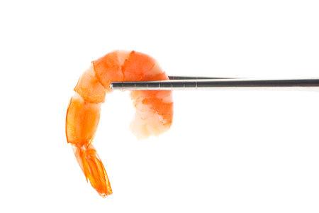 Isolated of cooked shrimp on chopsticks on white backgroundの写真素材