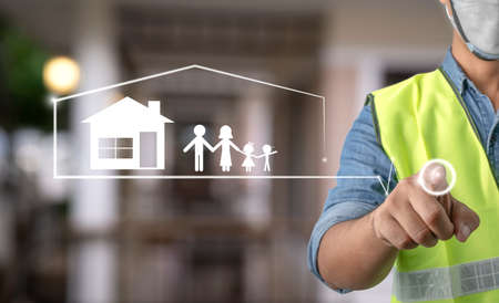 young engineer is starting to paint his own dream of having a home and family. dream house. loan mortgage and estate concept.の写真素材