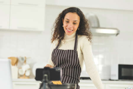 Beautiful young black woman is surprise near window in the bright white kitchen. wife or housewife is preparing to cook healthy food for the family. Stay at home.の写真素材