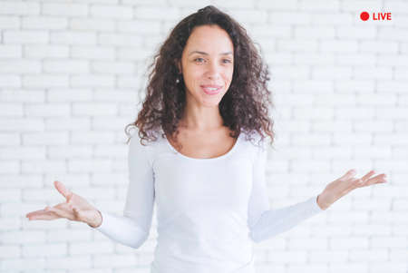 Candid shot of young blogger african american woman live streaming in social media. Employees report with video conferencing. Female trainer is training online by network internet and applicationの写真素材