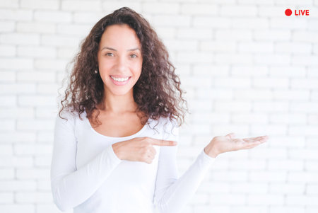 Young blogger african american woman looking at camera live streaming in social media. Employees report with video conferencing. Female trainer is training online by network internet and applicationの写真素材