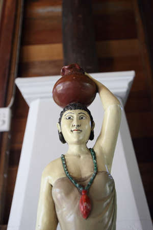 Statue of a woman carrying a container の写真素材