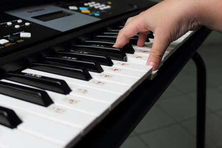 Kids practicing keyboard player の写真素材