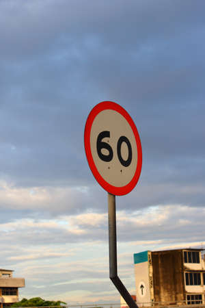 Speed limit sign 60 on sky background の写真素材