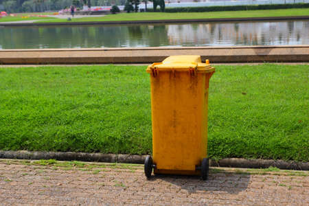 Trash can yellow in parkの写真素材