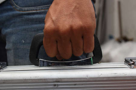 Close up hand of service technician hold a toolbox