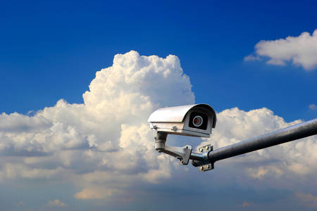 Security camera on blue sky backgroundの写真素材